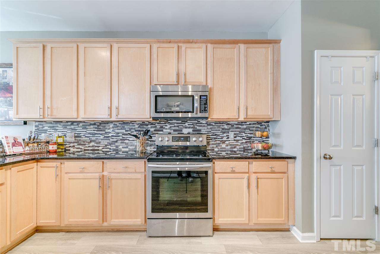 5319 Griffith Park Road Raleigh, NC 27613 - Photo 6 of 25 a kitchen with granite countertop white cabinets and stainless steel appliances