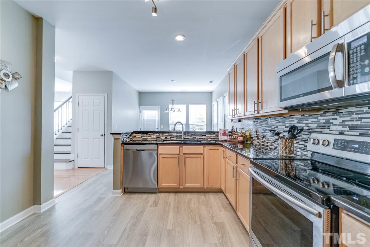 5319 Griffith Park Road Raleigh, NC 27613 - Photo 7 of 25 a kitchen with stainless steel appliances granite countertop a stove and a sink