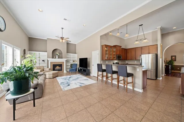 a living room with furniture a chandelier and a fireplace