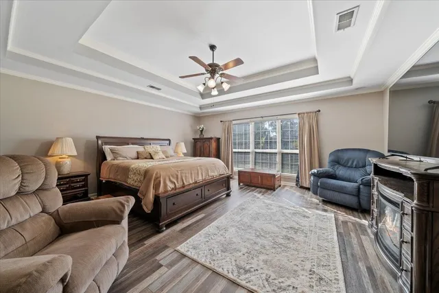 a living room with furniture a fireplace and kitchen view