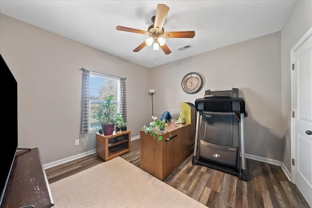 a room with a workspace and a couch