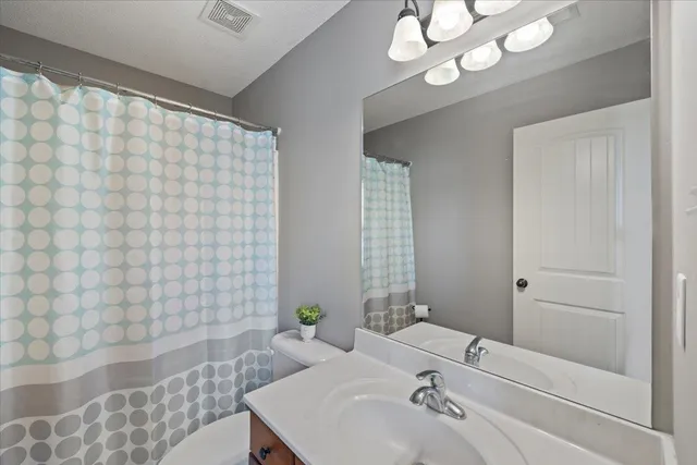 a bedroom with furniture and a wooden floor