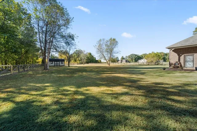 a view of a house with backyard and porch