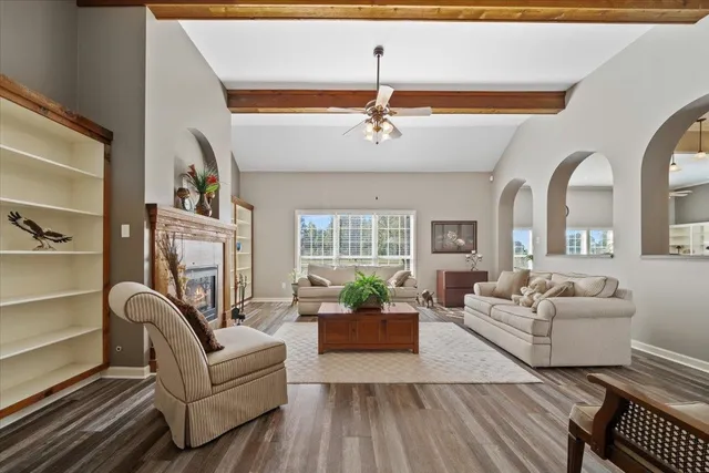 a living room with furniture or chandelier and a fireplace