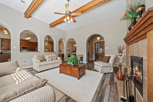 a living room with furniture fireplace and chandelier