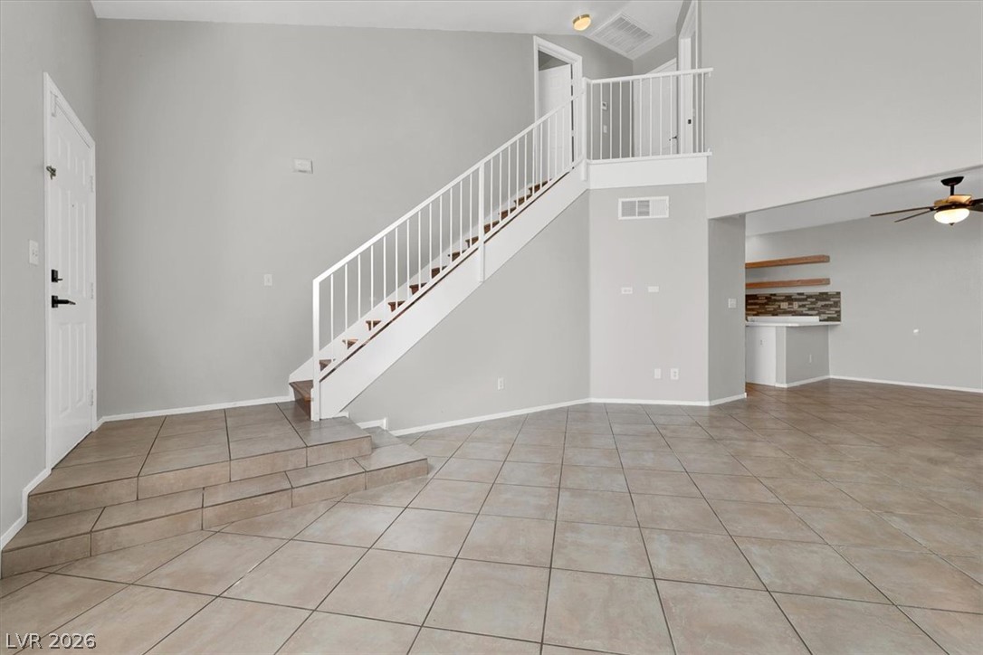 10148 Tree Bark Street Las Vegas, NV 89183 - Photo 5 of 37 A spacious entry leads to an open-concept living area with a sweeping staircase.