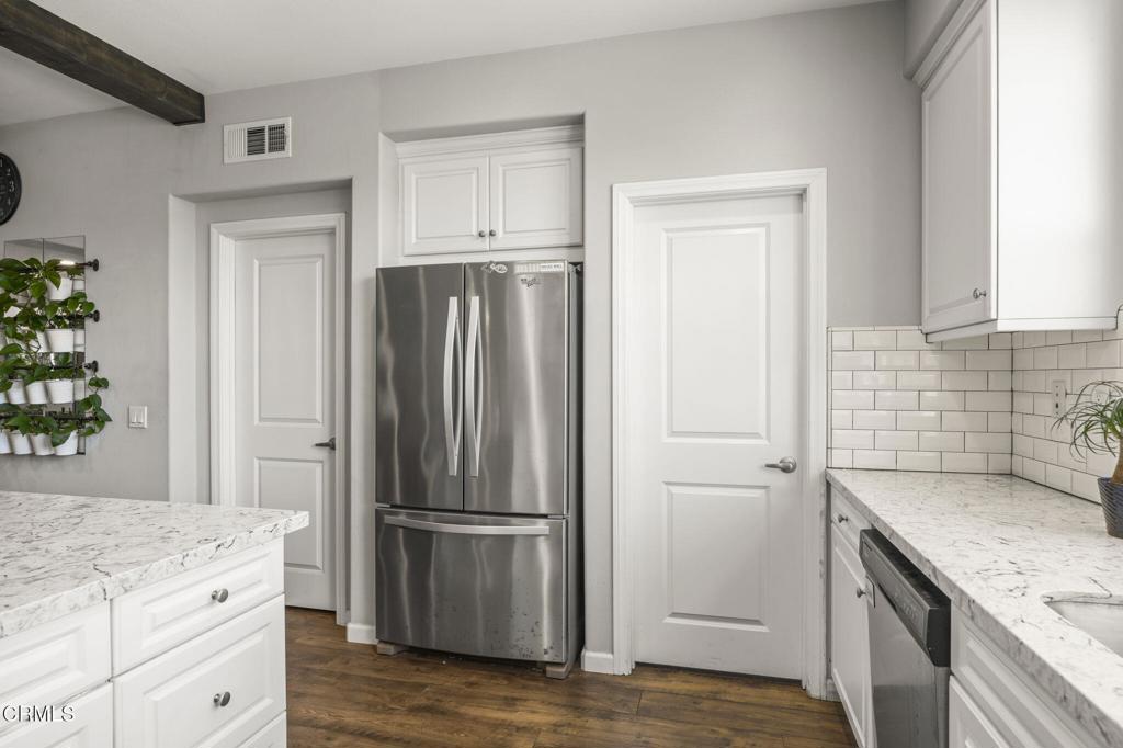 3644 Islander Walk Oxnard, CA 93035 - Photo 8 of 9 a kitchen with a refrigerator stove and cabinets