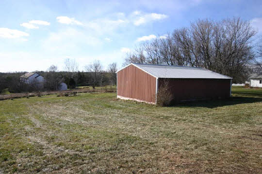 8331 Elevator Road Roscoe, IL 61073 - Photo 5 of 6 a backyard of a house with lots of green space