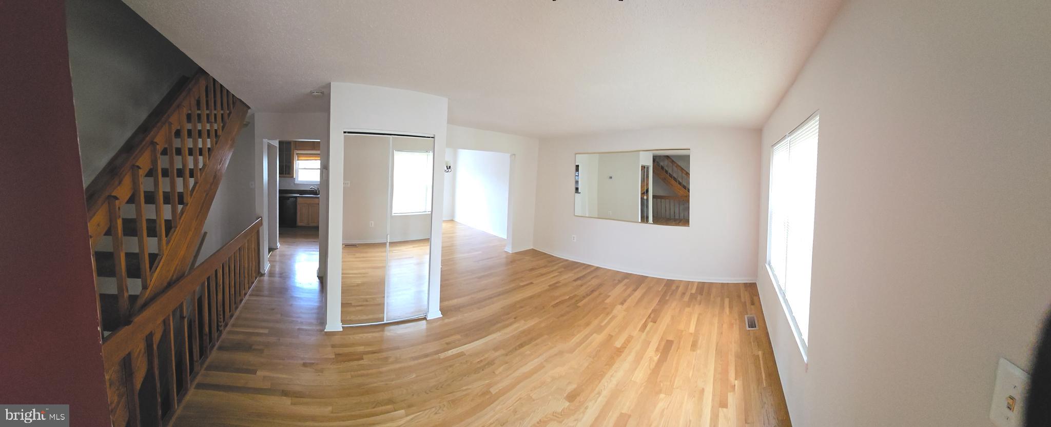 809 St Michaels Drive Bowie, MD 20721 - Photo 2 of 17 a view of a room with wooden floor and stairs