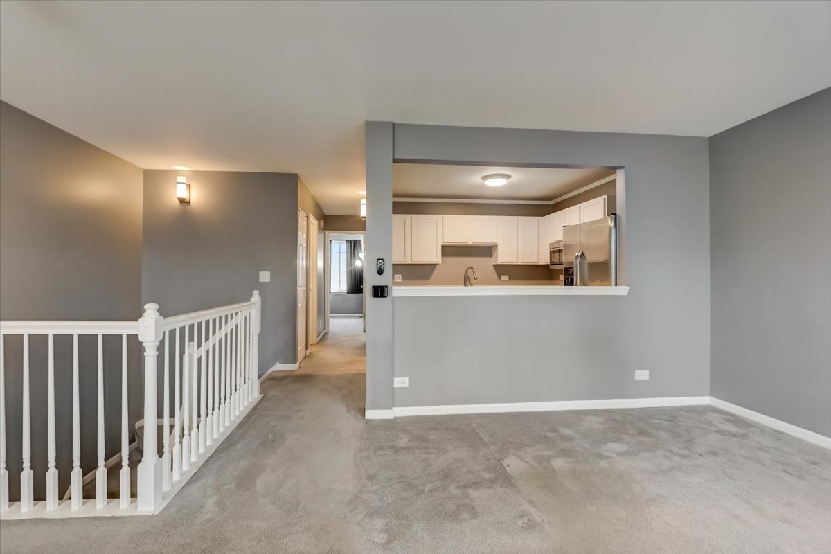 337 West Treehouse Lane, Unit 112 Round Lake, IL 60073 - Photo 11 of 33 a view of a hallway to a livingroom and a kitchen