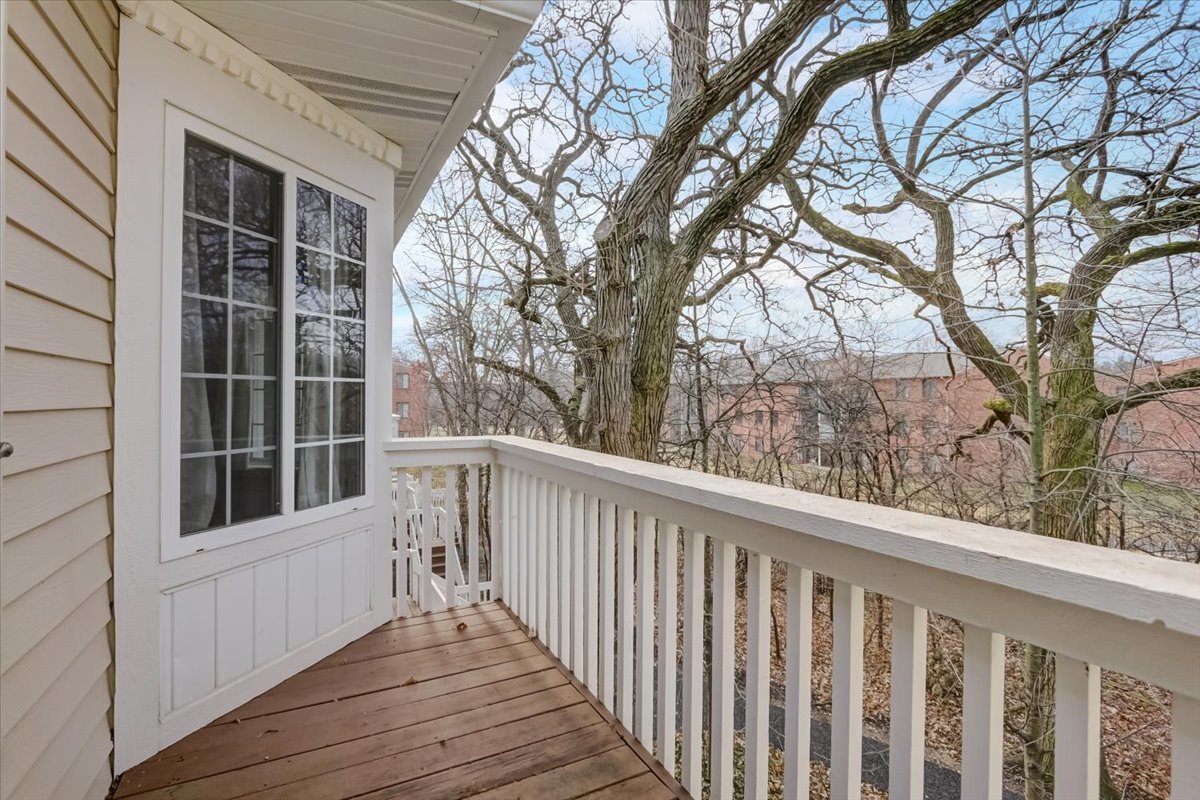 337 West Treehouse Lane, Unit 112 Round Lake, IL 60073 - Photo 30 of 33 a view of balcony with wooden floor and fence