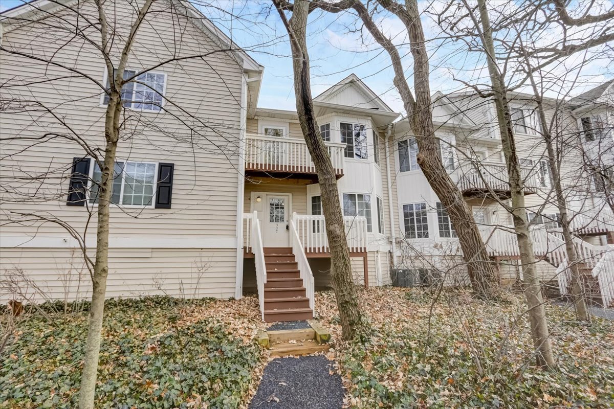 337 West Treehouse Lane, Unit 112 Round Lake, IL 60073 - Photo 4 of 33 a view of a white house next to a yard