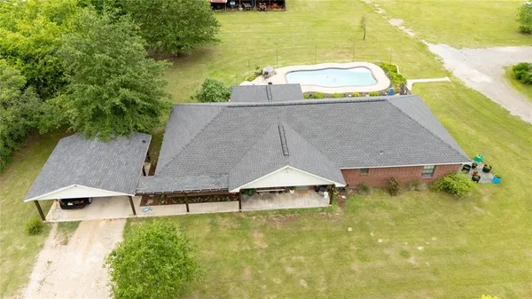 a view of a house with a big yard and a large tree