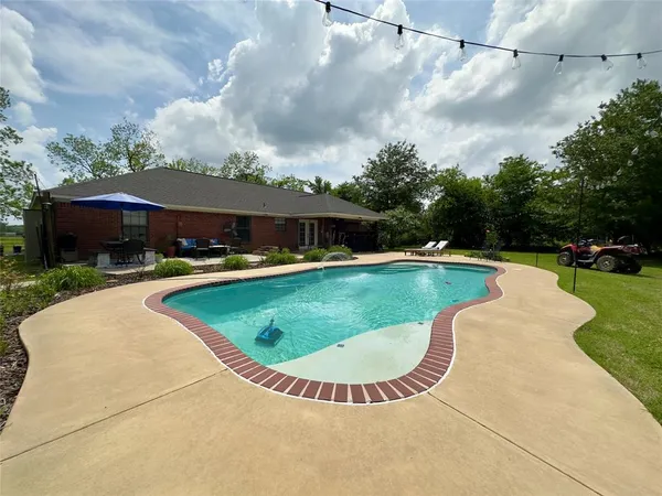a view of house with outdoor space and sitting area