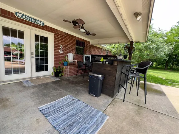 a view of a patio with a table and chairs