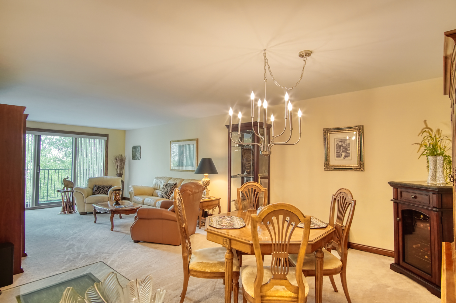 1-s150 Spring Road, Unit 4B Oak Brook, IL 60181 - Photo 3 of 19 a view of a dining room with furniture a livingroom and chandelier