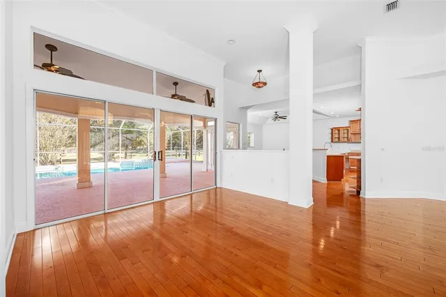 a view of a livingroom with wooden floor and a window