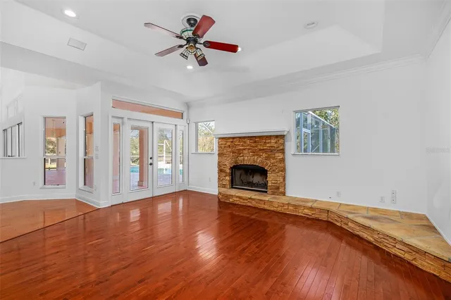a view of a room with a window and wooden floor