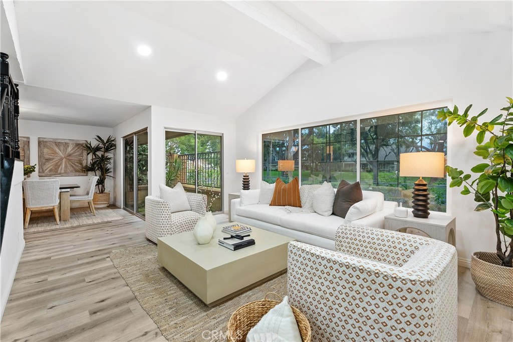 a living room with furniture large window and a table