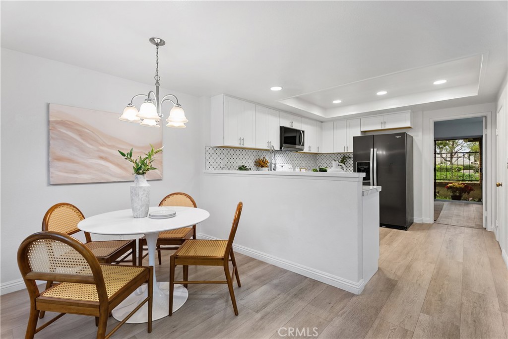 16 East Yale Loop, Unit 28 Irvine, CA 92604 - Photo 12 of 44 a view of a dining room with furniture window and wooden floor