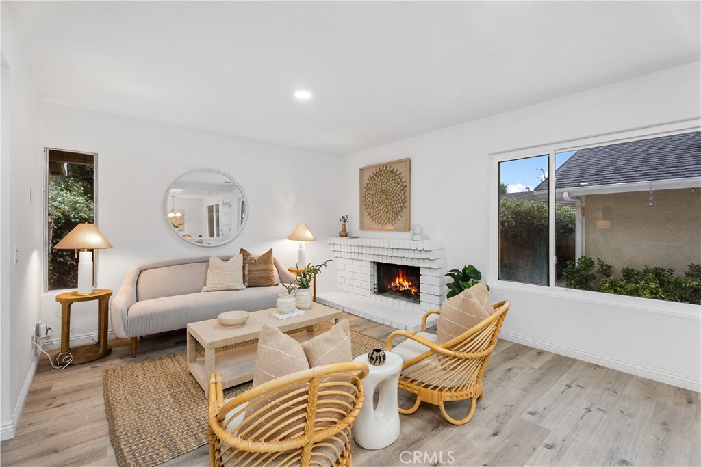 16 East Yale Loop, Unit 28 Irvine, CA 92604 - Photo 15 of 44 a living room with furniture a fireplace and a chandelier