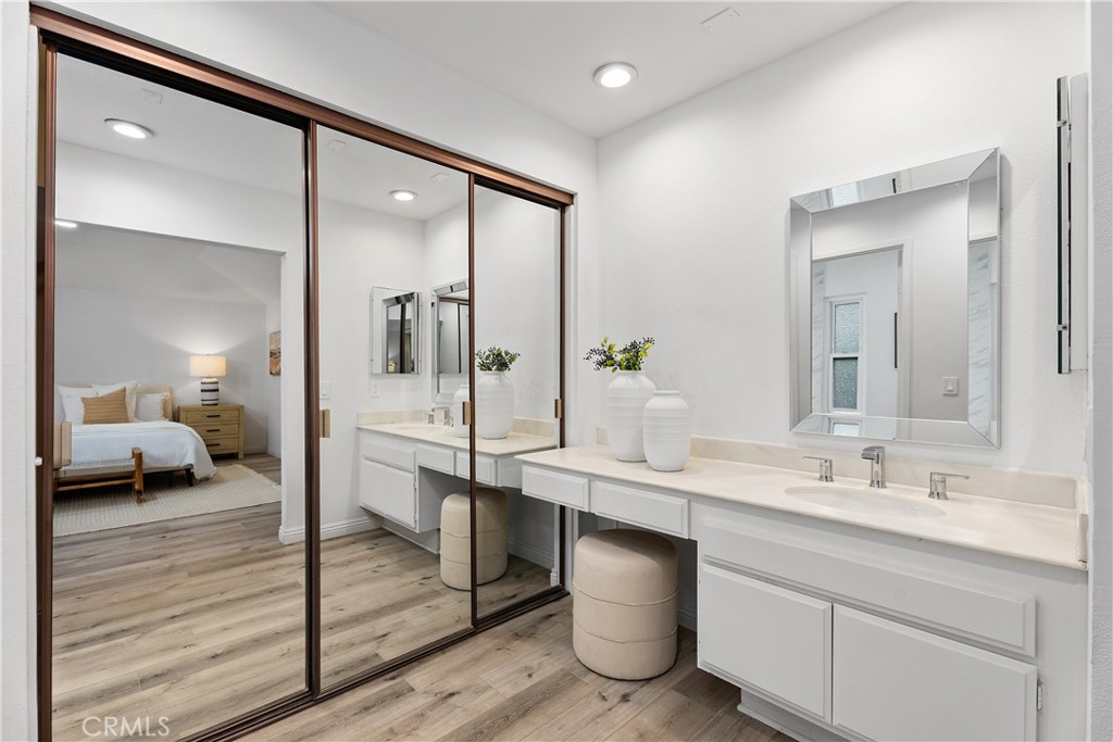 16 East Yale Loop, Unit 28 Irvine, CA 92604 - Photo 21 of 44 a en suite bathroom with a double vanity sink and a mirror