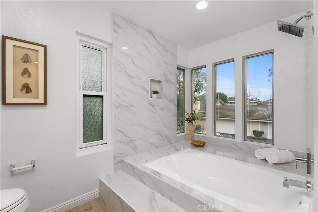 16 East Yale Loop, Unit 28 Irvine, CA 92604 - Photo 23 of 44 a bathroom with a granite countertop sink a toilet and shower