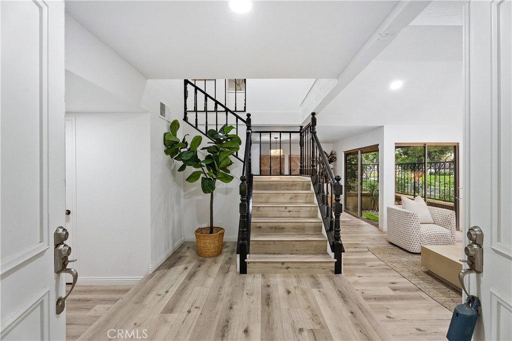 16 East Yale Loop, Unit 28 Irvine, CA 92604 - Photo 3 of 44 a view of entryway with wooden floor and a potted plant