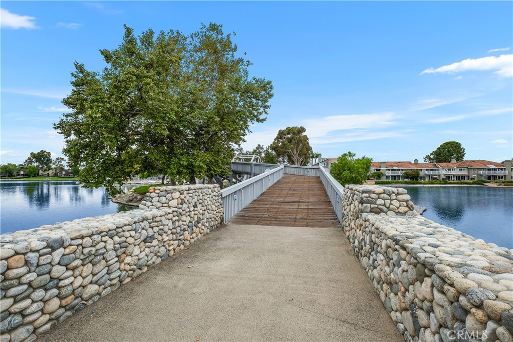 16 East Yale Loop, Unit 28 Irvine, CA 92604 - Photo 39 of 44 a view of a lake with a large building