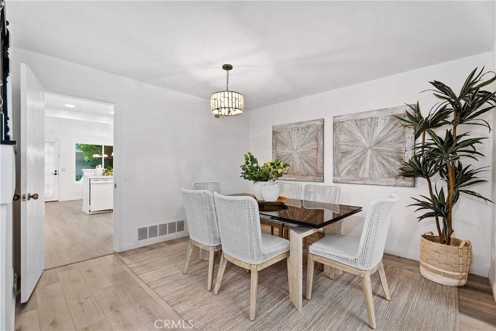 16 East Yale Loop, Unit 28 Irvine, CA 92604 - Photo 5 of 44 a view of a dining room with furniture and wooden floor