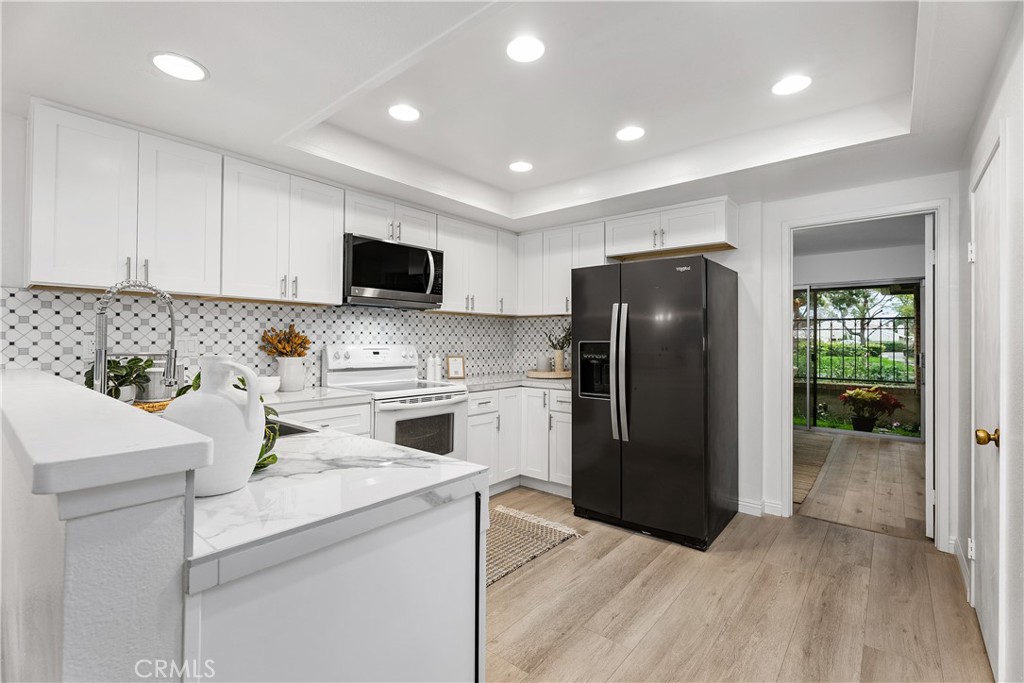 16 East Yale Loop, Unit 28 Irvine, CA 92604 - Photo 9 of 44 a kitchen with a refrigerator and a stove top oven