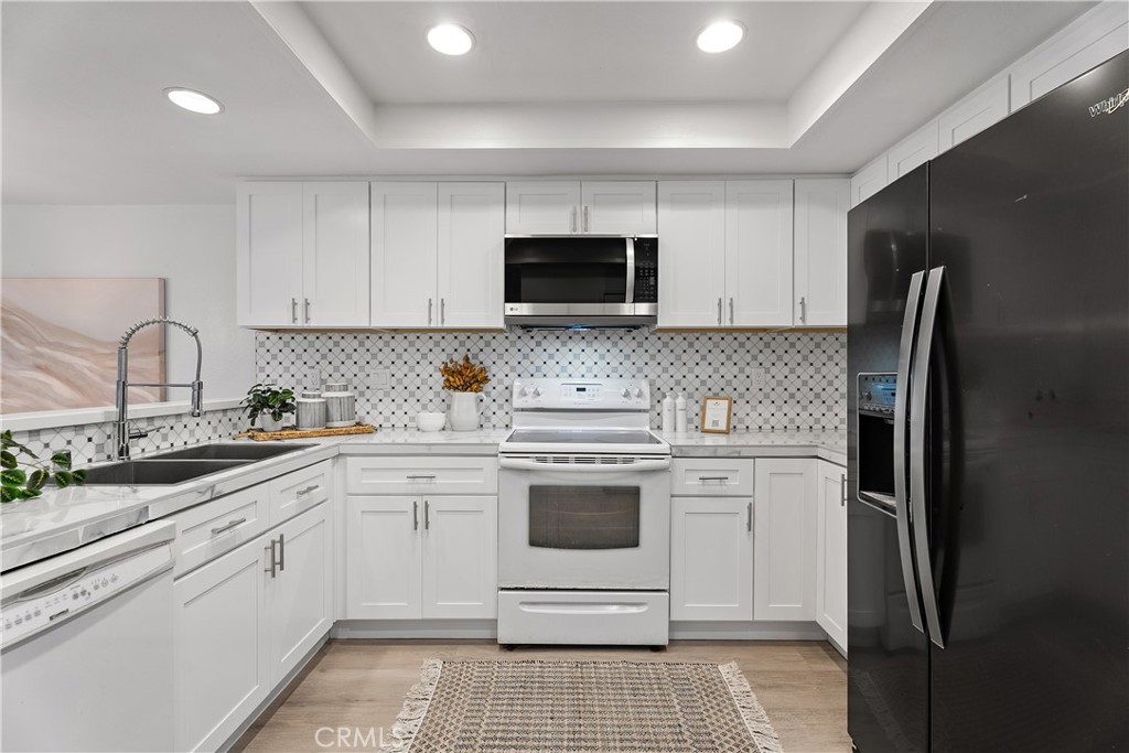 16 East Yale Loop, Unit 28 Irvine, CA 92604 - Photo 10 of 44 a kitchen with a sink stove and refrigerator