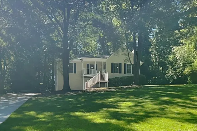 a view of a house with backyard and sitting area