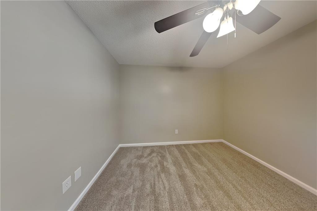5394 Muirwood Place Powder Springs, GA 30127 - Photo 11 of 18 a view of a room with wooden floor and fan