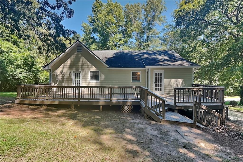 5394 Muirwood Place Powder Springs, GA 30127 - Photo 17 of 18 a view of a house with a small yard and wooden fence