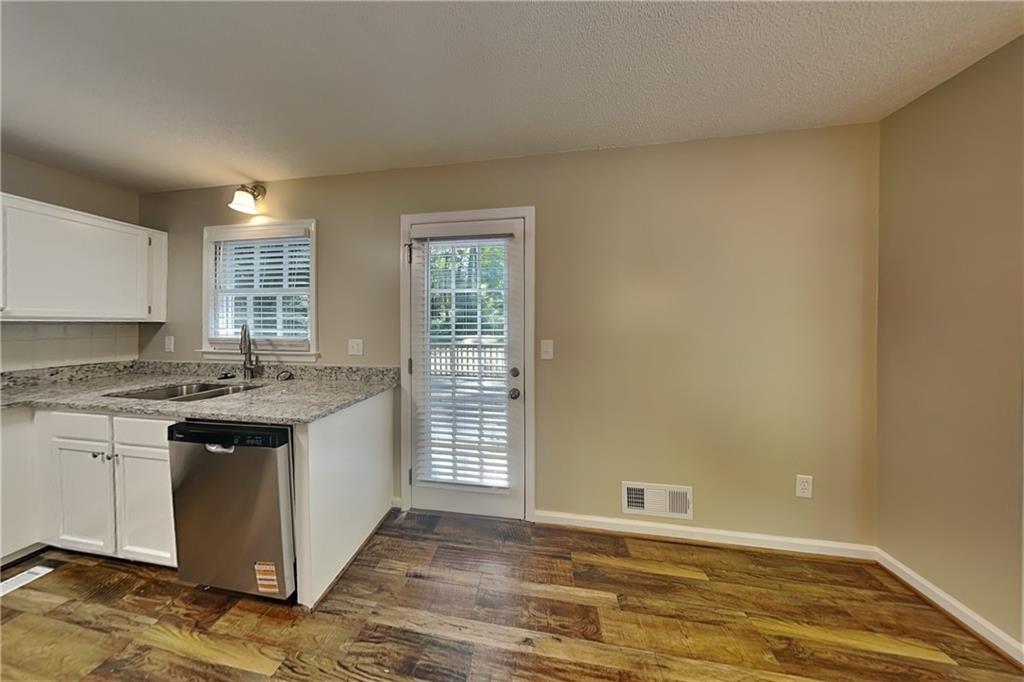 5394 Muirwood Place Powder Springs, GA 30127 - Photo 6 of 18 an empty room with wooden floor and a window