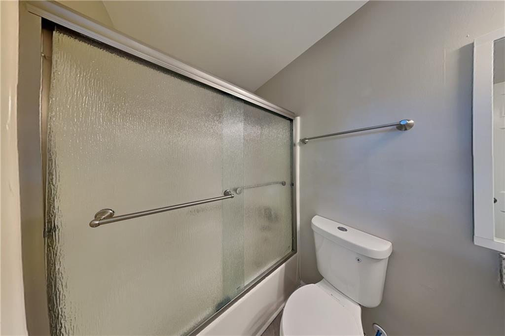 5394 Muirwood Place Powder Springs, GA 30127 - Photo 10 of 18 a bathroom with a toilet and a shower