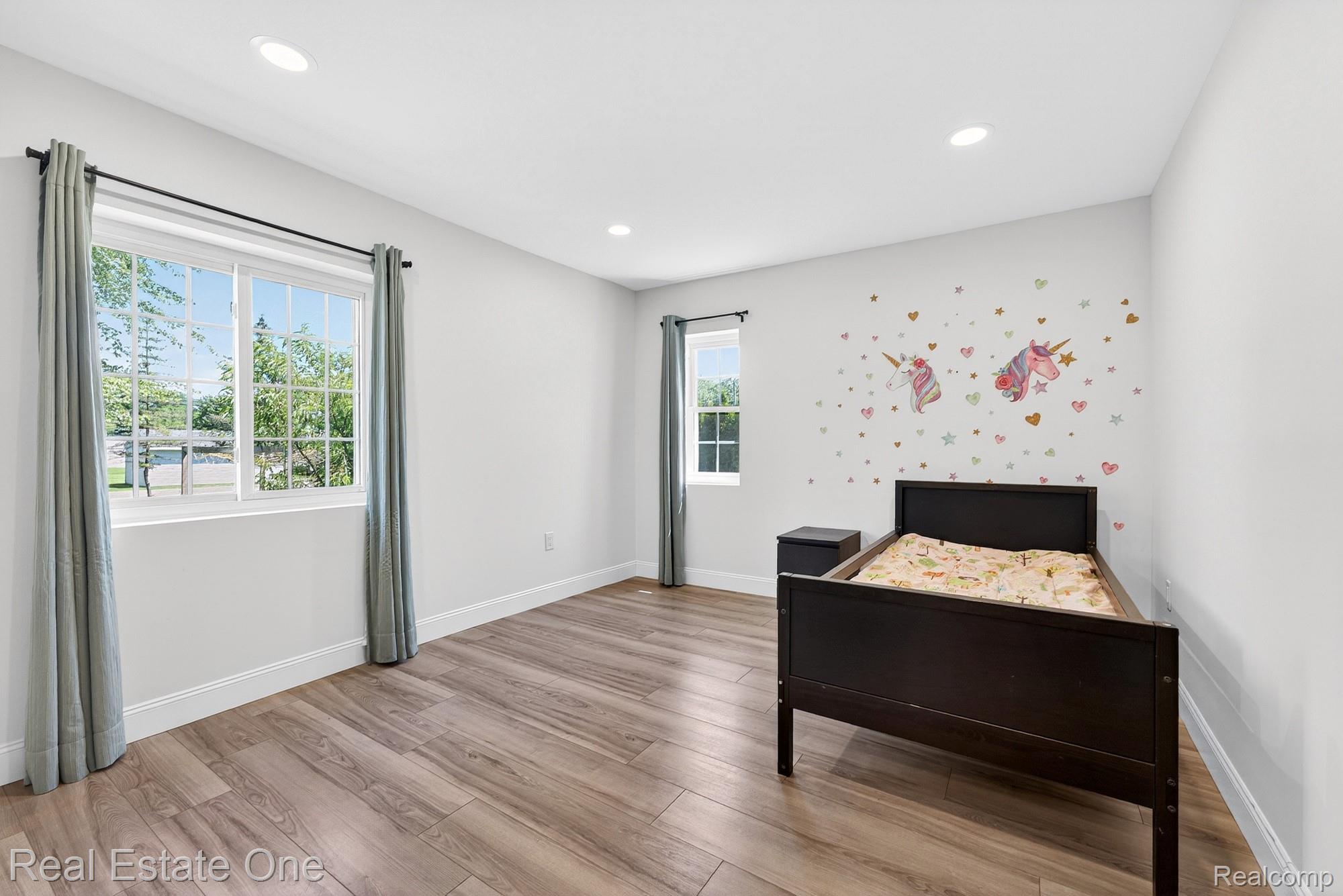 26987 Crawford Road Romulus, MI 48174 - Photo 17 of 51 Spacious room featuring wood-finish flooring, recessed lighting, and multiple windows