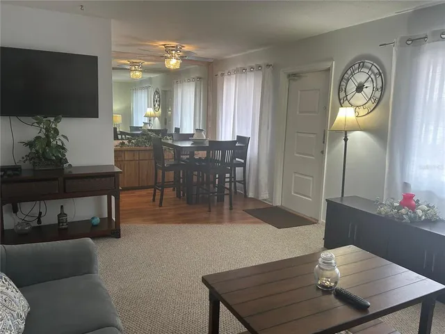 a room with wooden floor and electronic appliances
