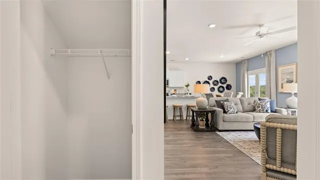 a living room with furniture and a dining table with kitchen view