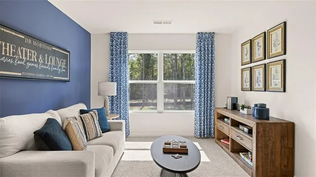 a bedroom with a bed and a dresser next to a window