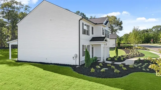 a view of a livingroom with wooden floor and a bathroom