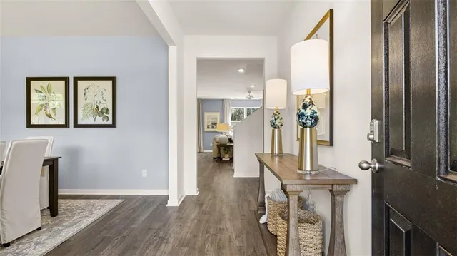 a view of a hallway view with wooden floor and furniture