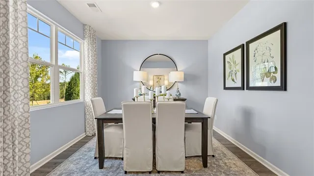 a dining room with furniture and a mirror