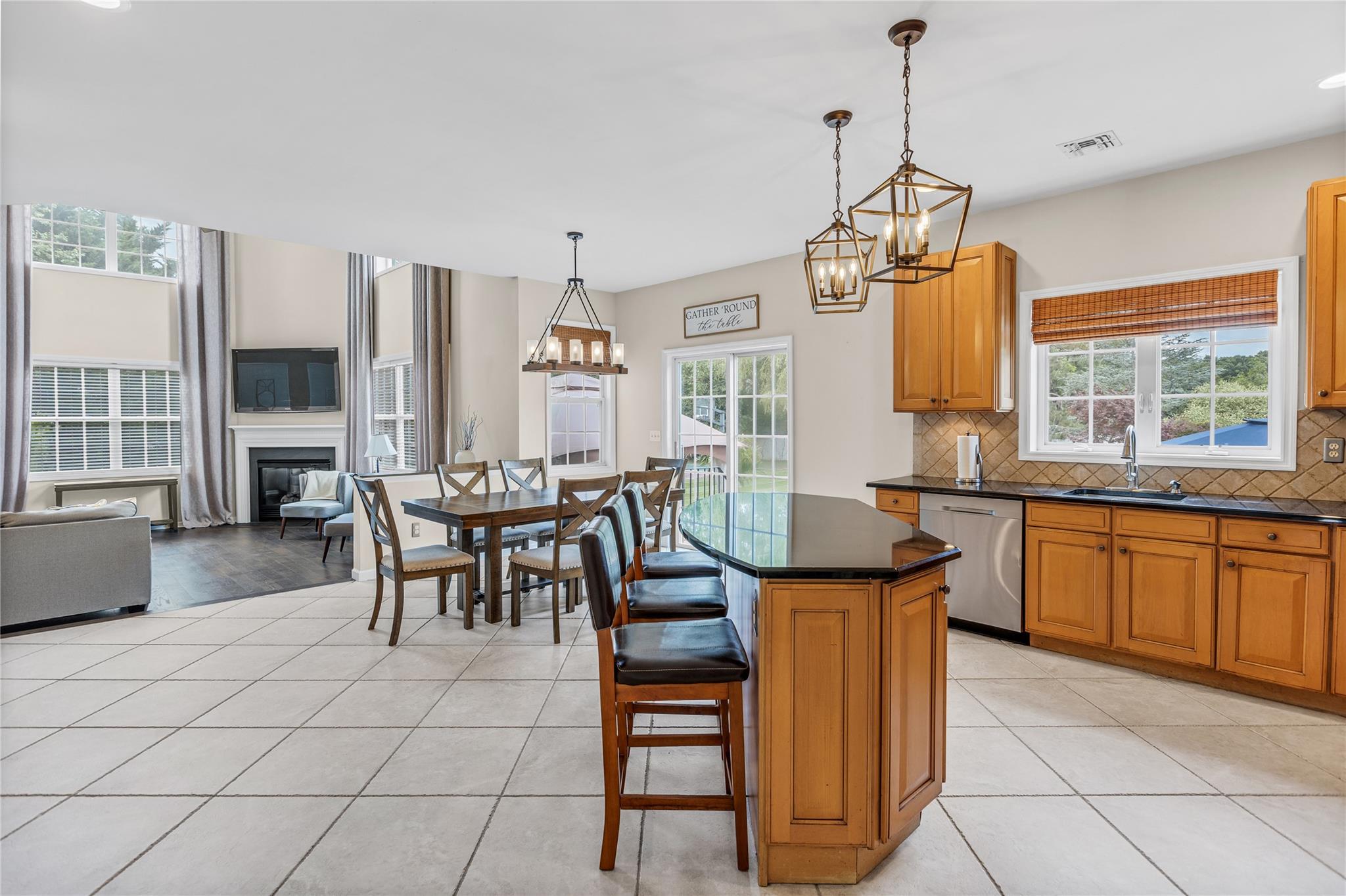 265 Hidden Acres Path Wading River, NY 11792 - Photo 11 of 46 Kitchen featuring stainless steel dishwasher, plenty of natural light, and dark countertops