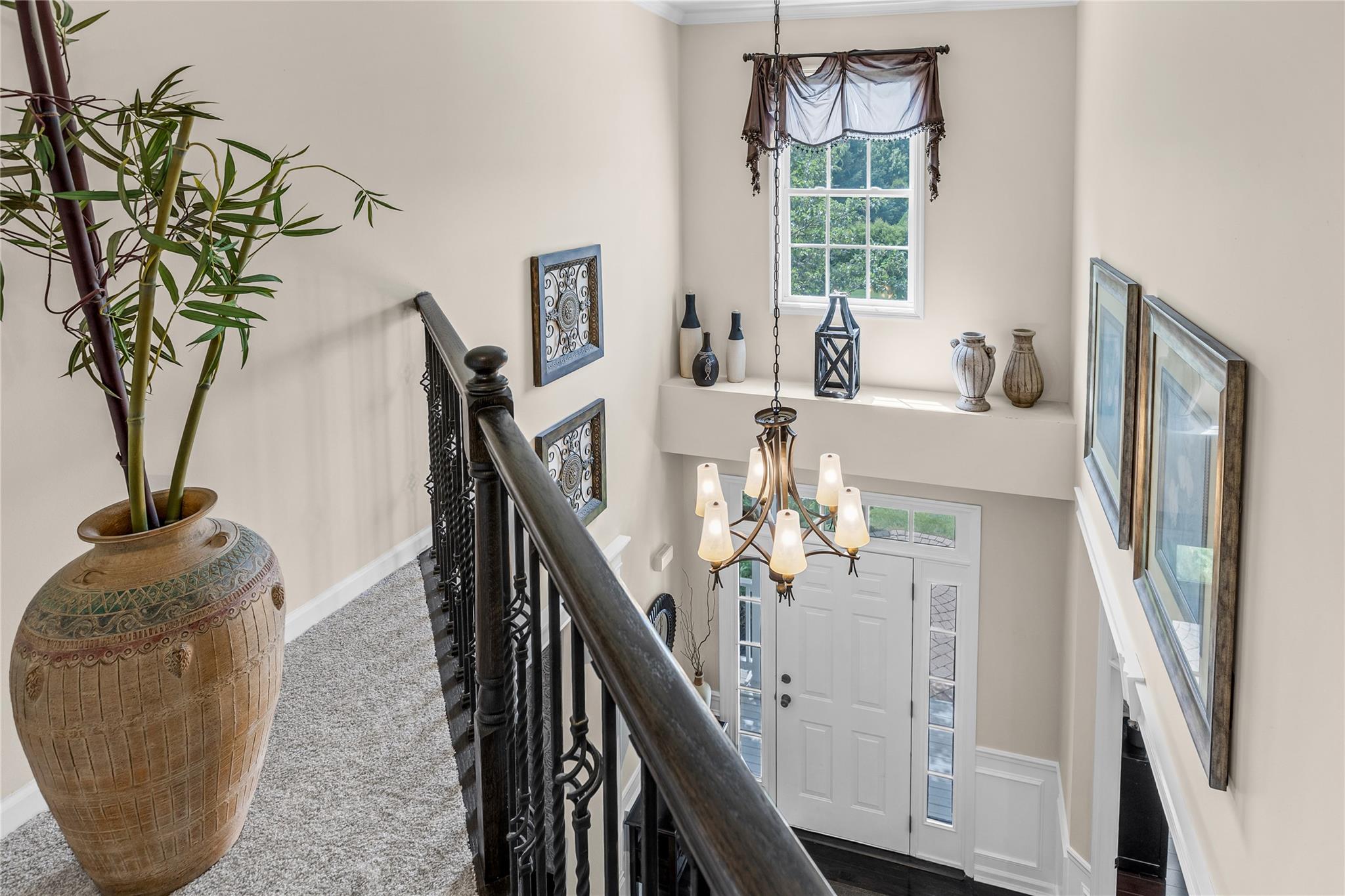 265 Hidden Acres Path Wading River, NY 11792 - Photo 15 of 46 Staircase featuring a chandelier, carpet floors, and crown molding
