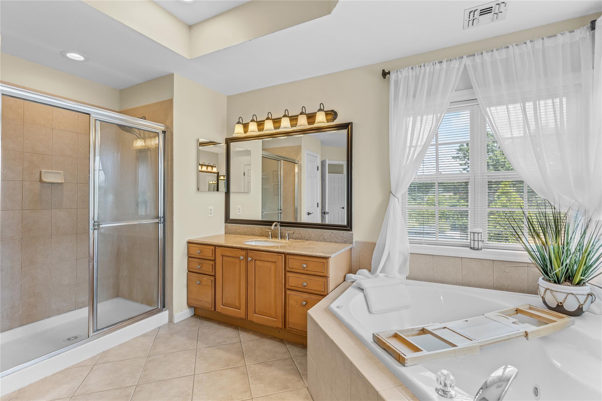 265 Hidden Acres Path Wading River, NY 11792 - Photo 18 of 46 Full bath with a whirlpool tub, vanity, tile patterned floors, and a stall shower