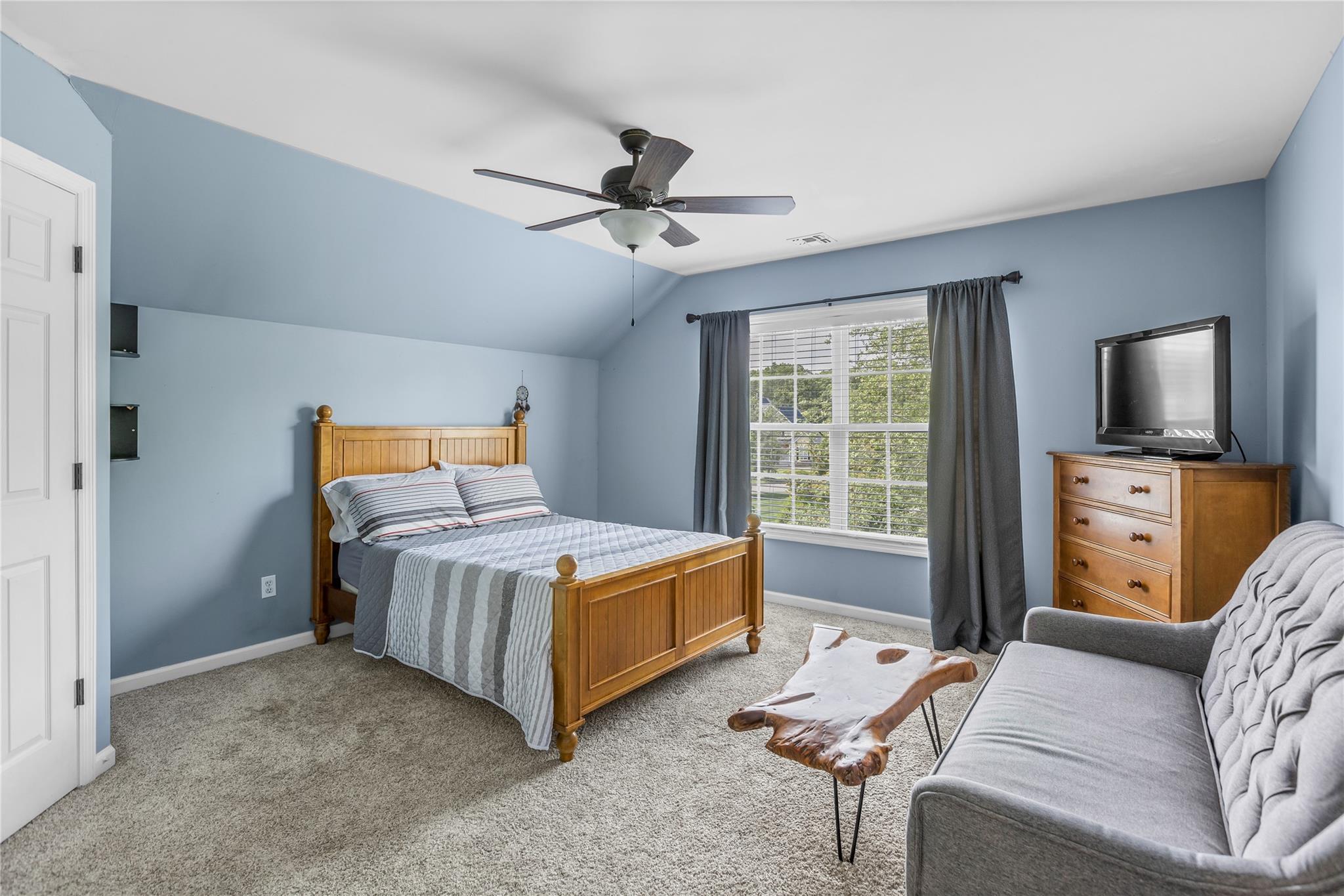 265 Hidden Acres Path Wading River, NY 11792 - Photo 19 of 46 Bedroom featuring lofted ceiling, light colored carpet, and a ceiling fan