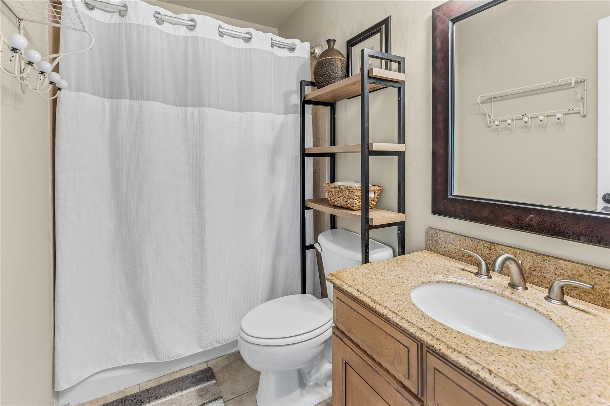 265 Hidden Acres Path Wading River, NY 11792 - Photo 22 of 46 Full bath featuring vanity, tile patterned floors, and shower / bath combination with curtain