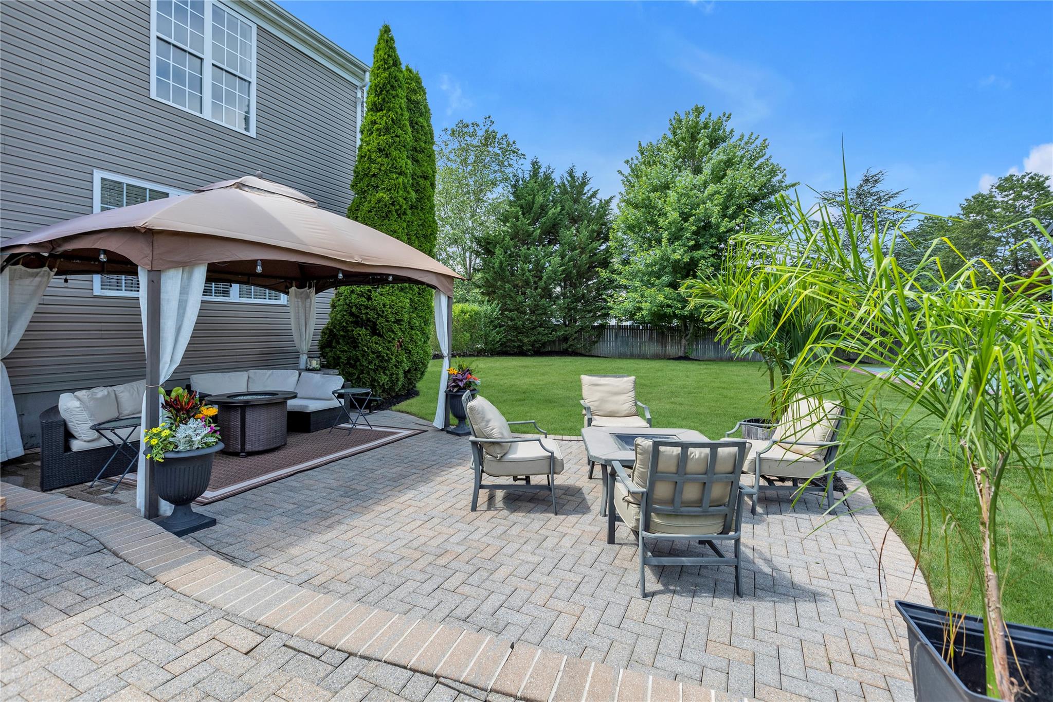 265 Hidden Acres Path Wading River, NY 11792 - Photo 34 of 46 Fenced backyard featuring an outdoor hangout area, a gazebo, a patio, and outdoor dining space
